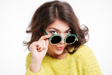 Stylish woman in sunglasses looking at camera