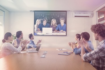 Fototapeta premium Composite image of a group of students with a laptop