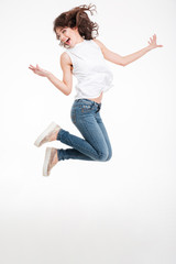 Full length portrait of a cheerful woman jumping