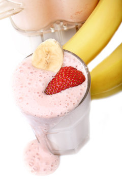 banana and strawberry smoothie on white background