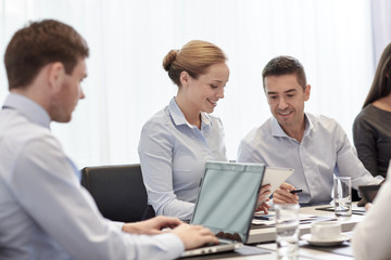 Fototapeta premium smiling business people with tablet pc in office