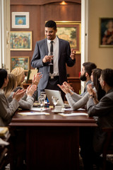  business group applauding during corporate meeting