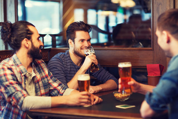 happy male friends drinking beer at bar or pub