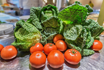 Tomatoes and white cabbage with leaves closeup
