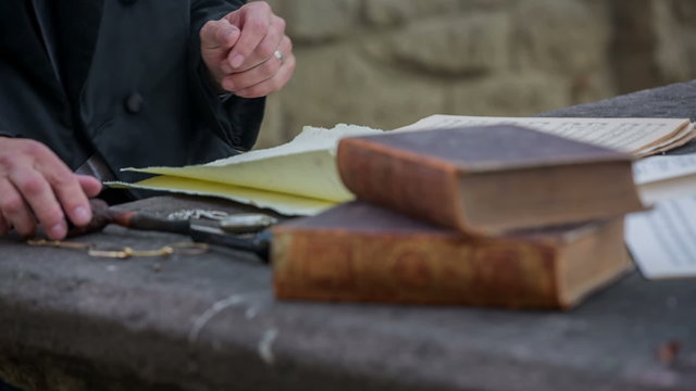 Composer looking at the clock on the table 
