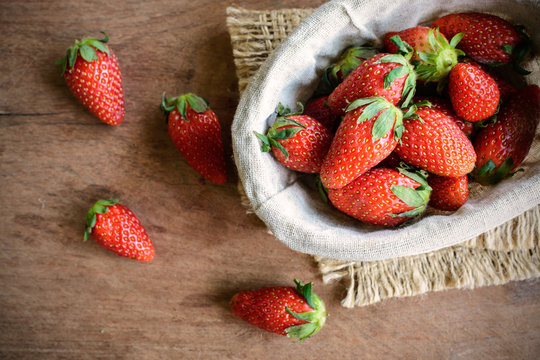 Fresh strawberries on rustic wooden table
