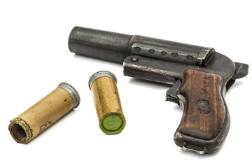 Old  signal pistol, flare gun and cartridges, isolated on white