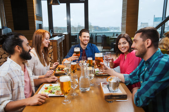 friends dining and drinking beer at restaurant