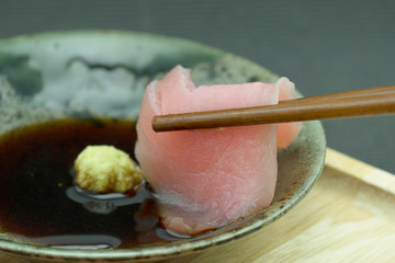 chopstick with tuna sasimi