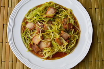 stir-fried white garlic chives with crispy pork on dish
