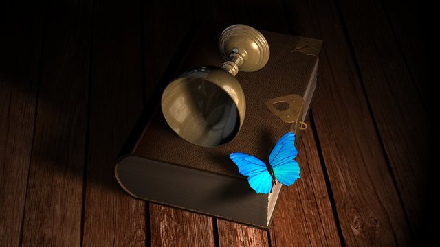 Old book with blue Butterfly and wine goblet on wooden table