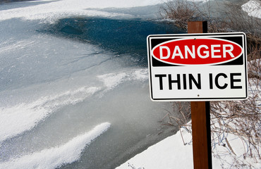 Thin Ice Warning Sign:  A sign warns of danger as ice thaws on a pond in southern Wisconsin.
 - Powered by Adobe