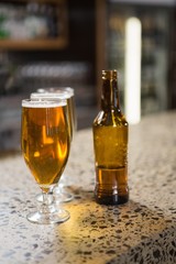 View of pints of beer and bottle