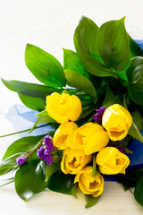 Obraz premium Bouquet of yellow tulips as a gift on Valentine's Day, on March