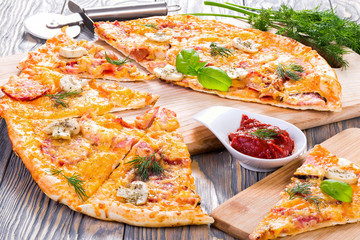 pizza with sausage, ham, mushrooms and cheese, close-up, macro