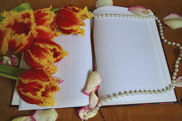 notebook with rose petals