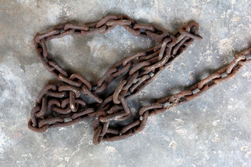 Rusted chain on concrete ground