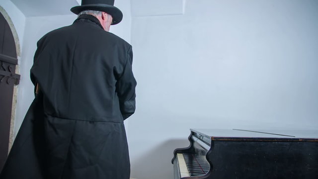 Romantic composer seating down at piano