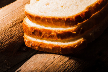 Fresh bread sliced on a wooden board