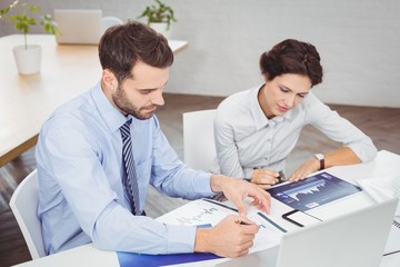 Business people working with documents in office