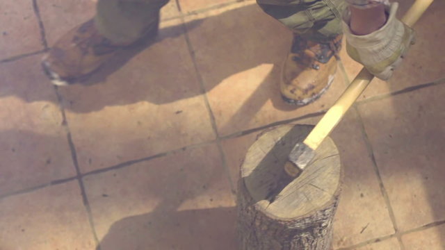 Hammering the axe in to the log 