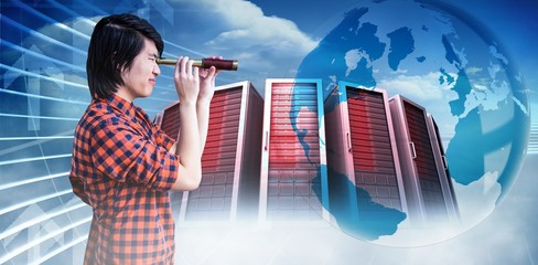 Composite image of hipster looking through a telescope