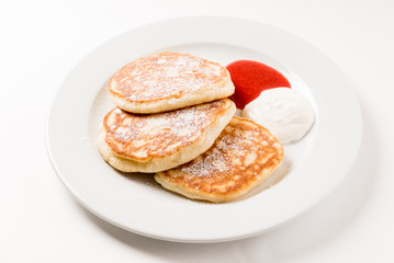 Obraz na płótnie Canvas tasty pancakes with sour cream and jam