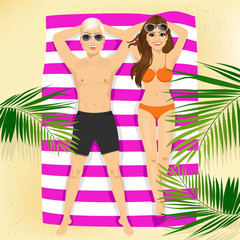 happy couple with sunglasses lying on colorful beach towel