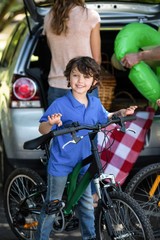 Fototapeta na wymiar Smiling boy with his bike