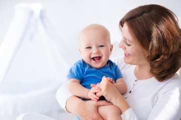 Happy young mother with baby boy at home