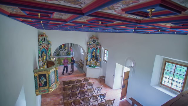 Two senior people observing the inside of the church