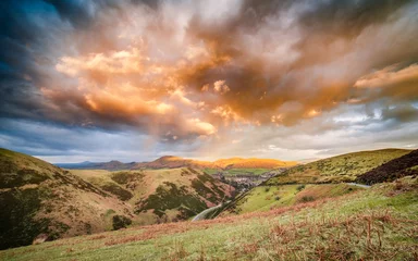 Wall murals Hill Dramatic Sunset Clouds Over Carding Mill Valley, Shropshire Hill