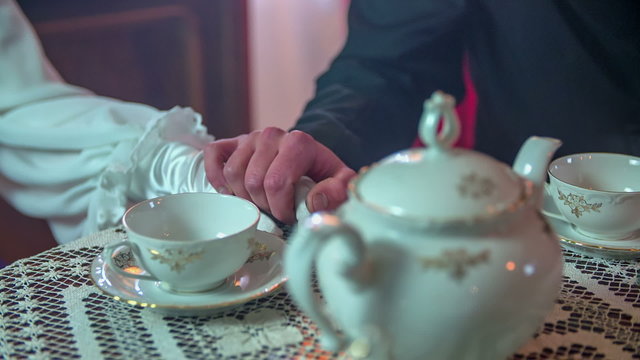 Grbbing her hand on the table 