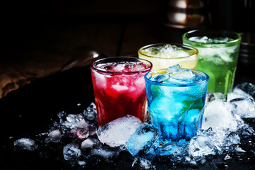 Alcoholic cocktail with crushed ice on a dark background, select