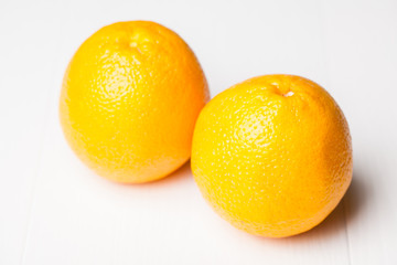 fresh yellow oranges on white background