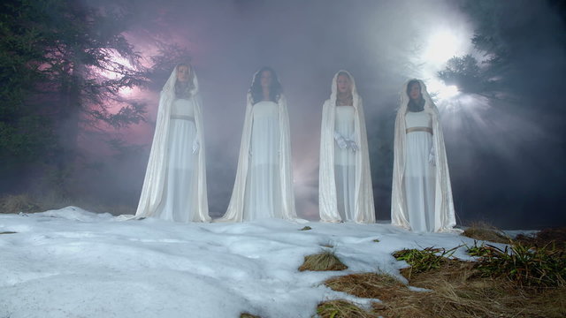 Four angels are standing on a hill