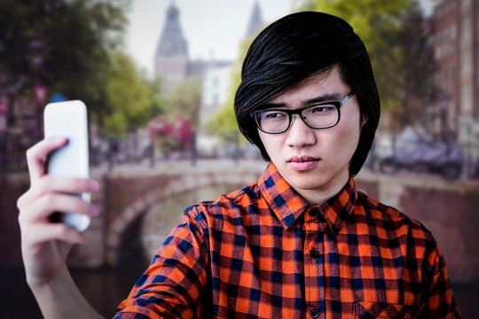Composite image of cinfident hipster taking a selfie