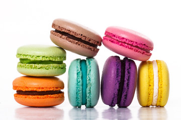 Collection of brightly colored French macarons on white backgrou