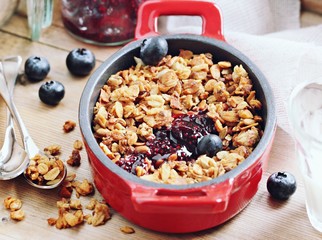 Blueberry granola crisp. Clean-eating gluten free dessert . Superfoods concept.Toned image, selective focus.