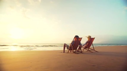 4K Retirement Vacation Concept, Happy Mature Retired Couple Enjoying Beautiful Sunset at the Beach