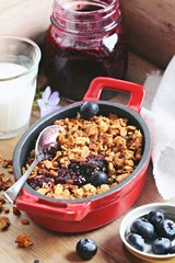 Blueberry granola crisp. Clean-eating gluten free dessert . Superfoods concept.Toned image, selective focus.