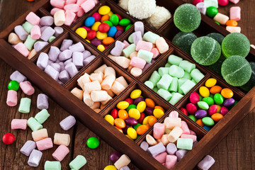 Mix of candies and sweets in wooden box