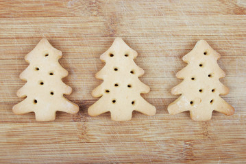 Homemade cookies in the form of spruce on a wooden board