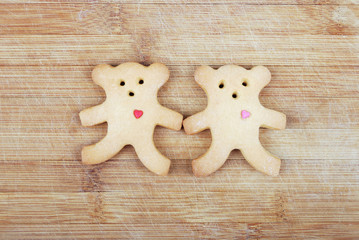 Homemade cookies in the shape of a little bear on a wooden board