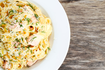 tasty pasta with salmon, dill on plate