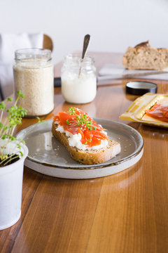 Sandwich with smoked salmon, cottage cheese, garden cress and sesame seeds. Selective focus.