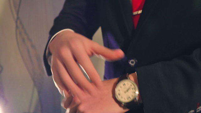 man businessman in suit jacket looks at the clock