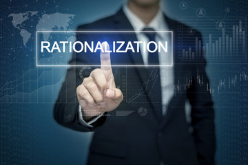 Businessman hand touching RATIONALIZATION  button on virtual scr