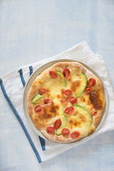Pizza with avocado, cherry tomatoes and mozarella