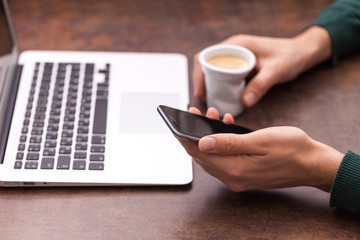 close up hands multitasking man using laptop connecting wifi
